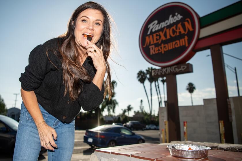 LONG BEACH, CA - SEPTEMBER 19, 2023: Tiffani Thiessen  digs into a cheese enchilada at Pancho's in Long Beach 