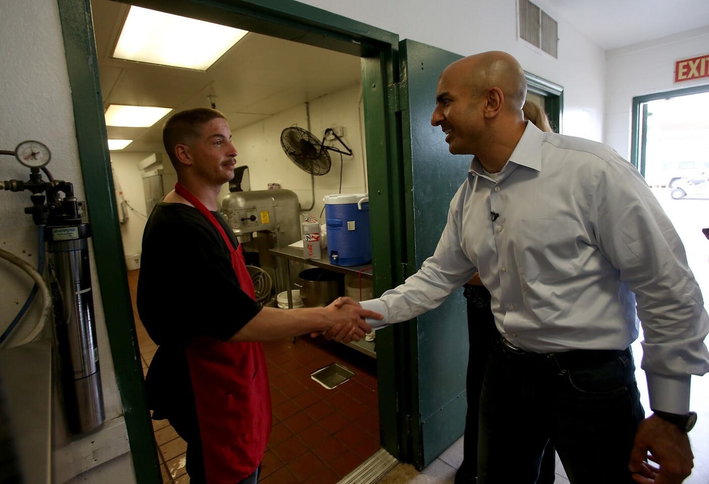 Republican gubernatorial candidate Neel Kashkari tours the Fresno Rescue Mission. Kashkari opposes Gov. Jerry Brown's plan to build a high-speed rail system between the Bay Area and Southern California. The mission is next to the proposed route of the trains.