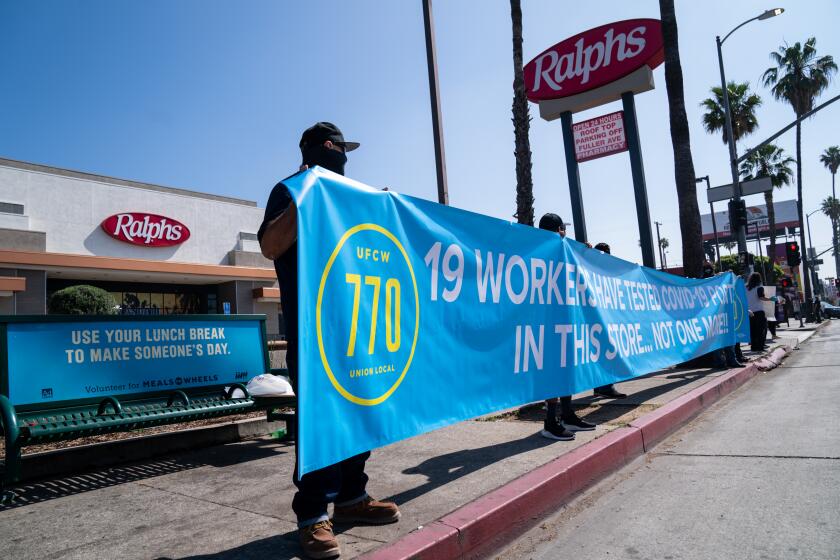 LOS ANGELES, CA - MAY 01: Grocery Store workers along with UFCW 770 representatives and community members hold a social distancing rally at the Hollywood Ralph's on Friday, May 1, 2020 in Los Angeles, CA. Workers at the Ralph's on Sunset have said that 19 employees have tested positive for COVID-19/Coronavirus and they are protesting working conditions for frontline/essential workers. (Kent Nishimura / Los Angeles Times)