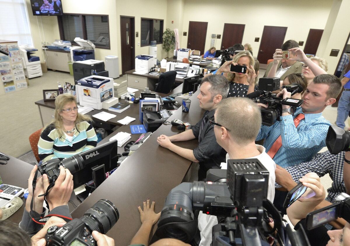 Surrounded by the media, David Moore, center in dark shirt, and his partner David Ermold attempt to apply for a marriage license at the Rowan County Courthouse in Morehead, Ky., on Sept. 1, 2015. They were turned away.