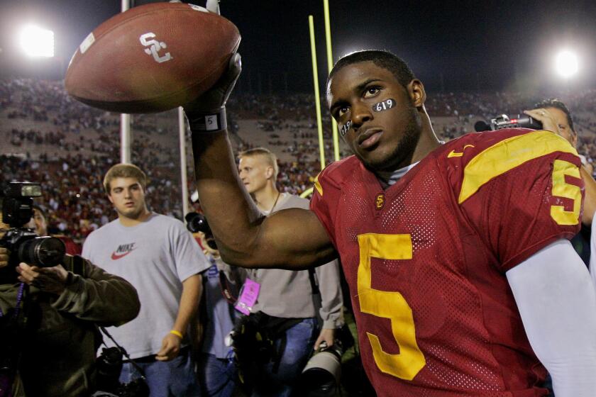FILE - In this Nov. 19, 2005, file photo, Southern California tail back Reggie Bush walks off the field holding the game ball after the Trojans defeated Fresno State, 50-42, at the Los Angeles Coliseum. Former Southern California star Reggie Bush, who had his Heisman Trophy victory in 2005 vacated for committing NCAA violations, is among the players making their first appearance on the College Football Hall of Fame ballot this year. The National Football Foundation announced on Wednesday, June 2, 2021, the players eligible for election into the Hall of Fame, and 26 of the 77 FBS players will be debuting on the ballot. (AP Photo/Kevork Djansezian, File)