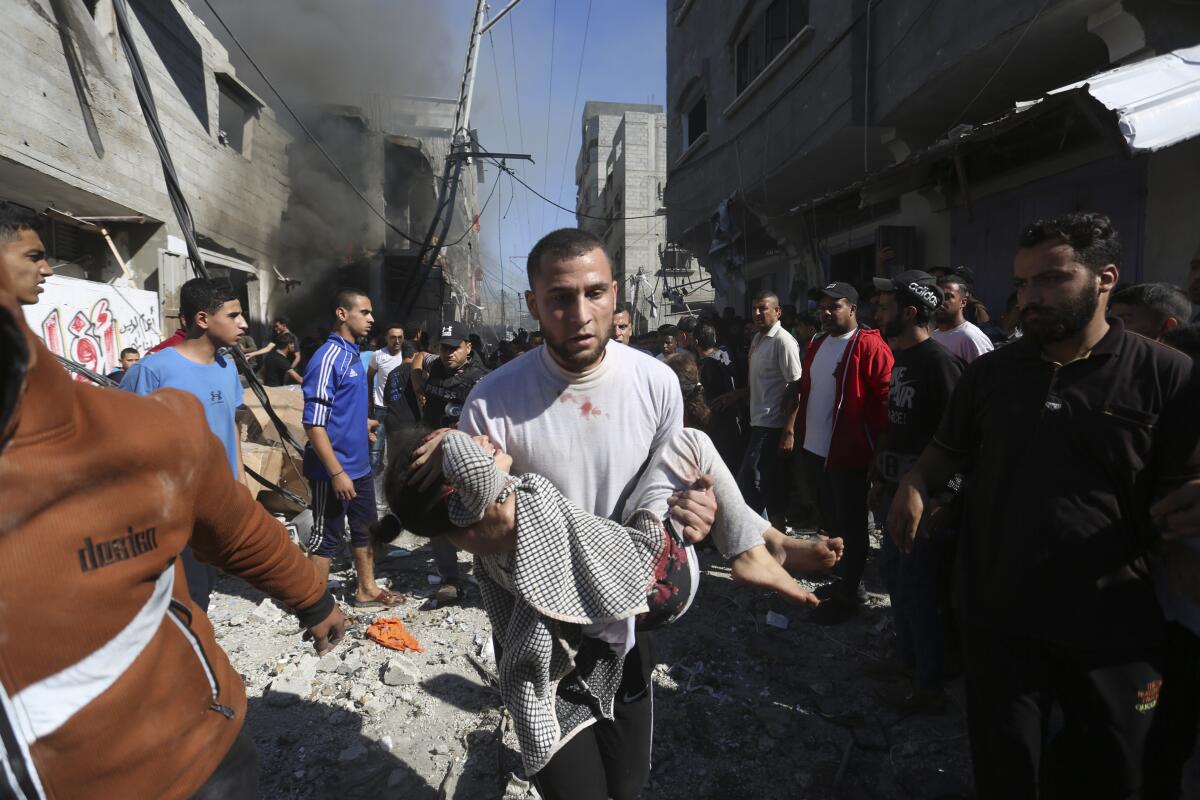 Palestinians rescue survivors after an Israeli strike on Rafah in the Gaza Strip on Friday.