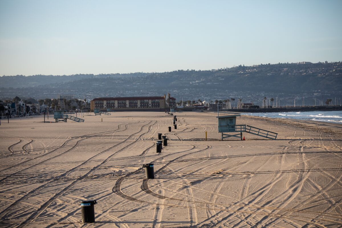 The Strand walking path and the beach at Hermosa Beach are closed to slow the spread of the coronavirus.