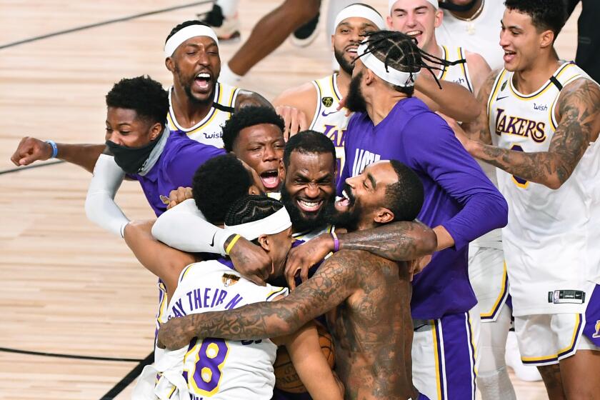 ORLANDO, FLORIDA OCTOBER 11, 2020-Laker players including LeBron James, center, celebrate.