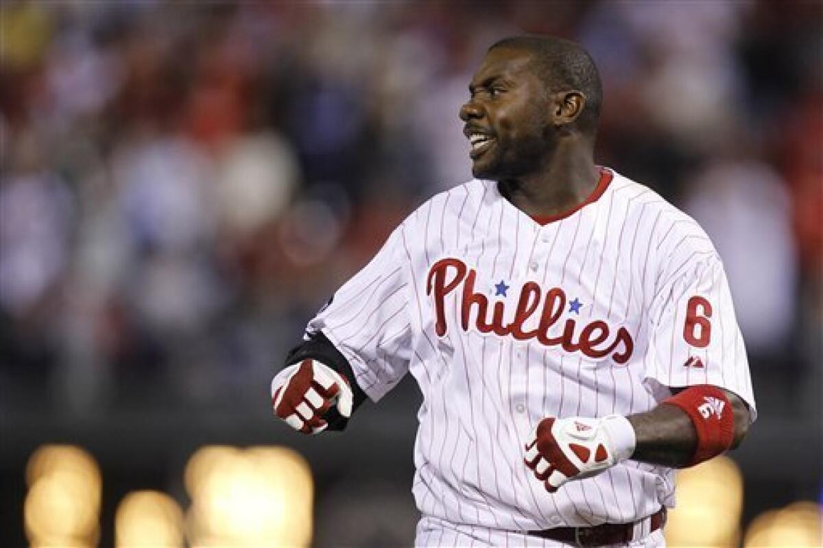 Philadelphia Phillies' Ryan Howard swings his bat as he walks to