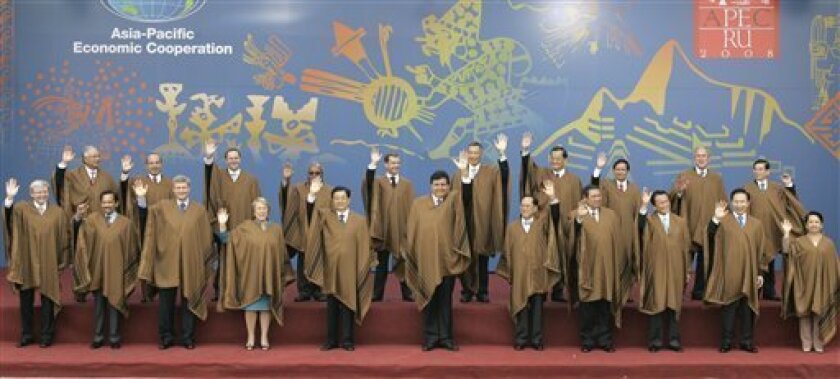 Leaders, wearing traditional Peruvian ponchos, wave during the official group photo of 16th summit of the Asian Pacific Economic Cooperation, APEC, in Lima, Sunday, Nov. 23, 2008. Front row from left to right, Australia's Primer Minister Kevin Rudd, Brunei's Sultan Haji Hassanal Bolkiah, Canada's Prime Minister Stephen Harper, Chile's President Michelle Bachelet, China's President Hu Jintao, Peru's President Alan Garcia, Hong Kong's Chief Executive Donald Tsang, Indonesia's President Susilo Bambang Yudhoyono, Japan's Prime Minister Taro Aso, South Korea's President Lee Myung-bak, Philippines' President Gloria Macapagal Arroyo. Back row from left to right, Malaysia's Deputy Prime Minister Najib Razak, Mexico's President Felipe Calderon, New Zealand's Prime Minister John Key, Papua New Guinea's Prime Minister Michael Somare, Russia's President Dmitry Medvedev, Singapore's Prime Minister Lee Hsien Loong, Taipei's former Vice President Lien Chan, Thailand's Prime Minister Somchai Wongsawat, US President George W. Bush, Vietnam's President Nguyen Minh Triet. (AP Photo/Dado Galdieri)