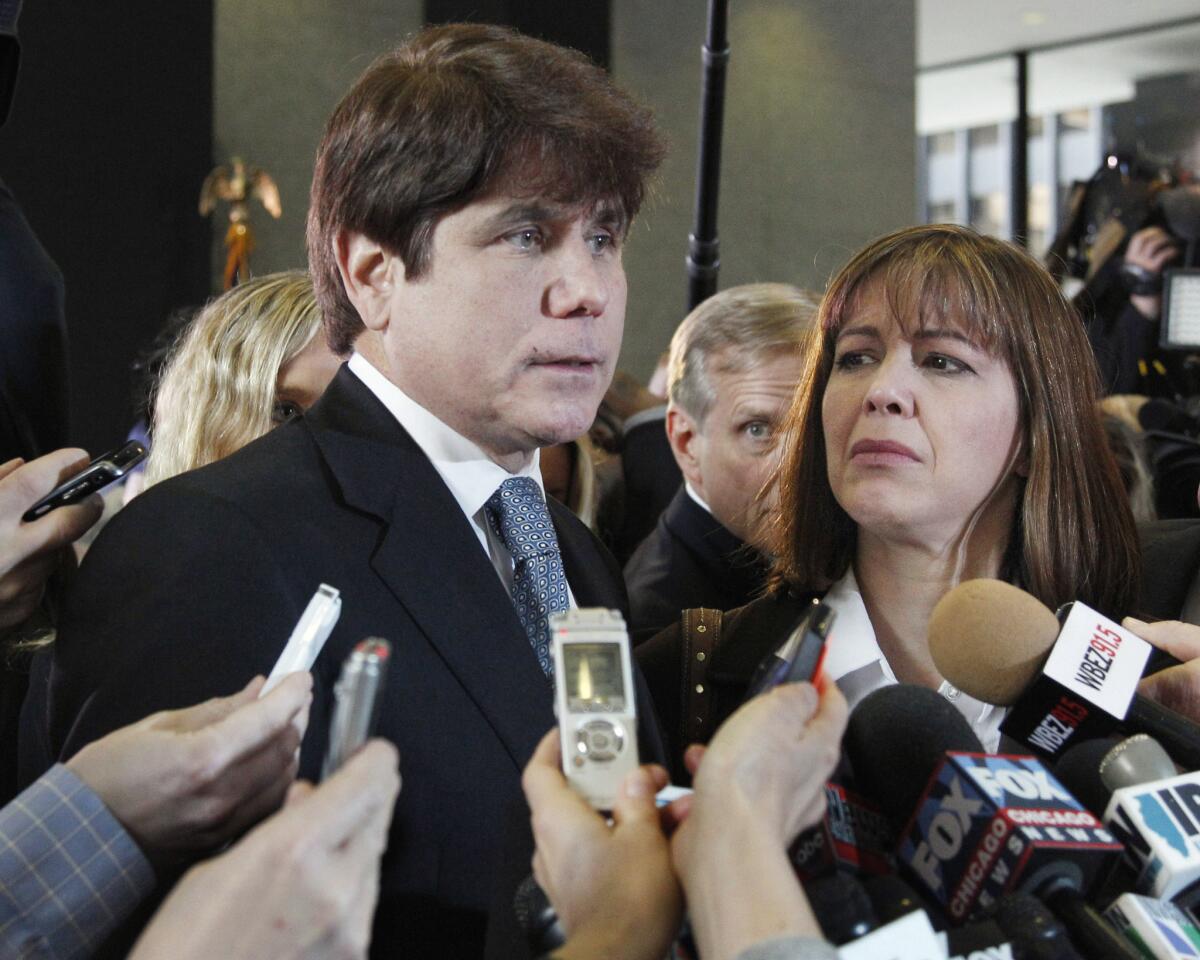 In this Dec. 7, 2011 file photo, former Illinois Gov. Rod Blagojevich, left, speaks to reporters as his wife, Patti, listens at the federal building in Chicago.