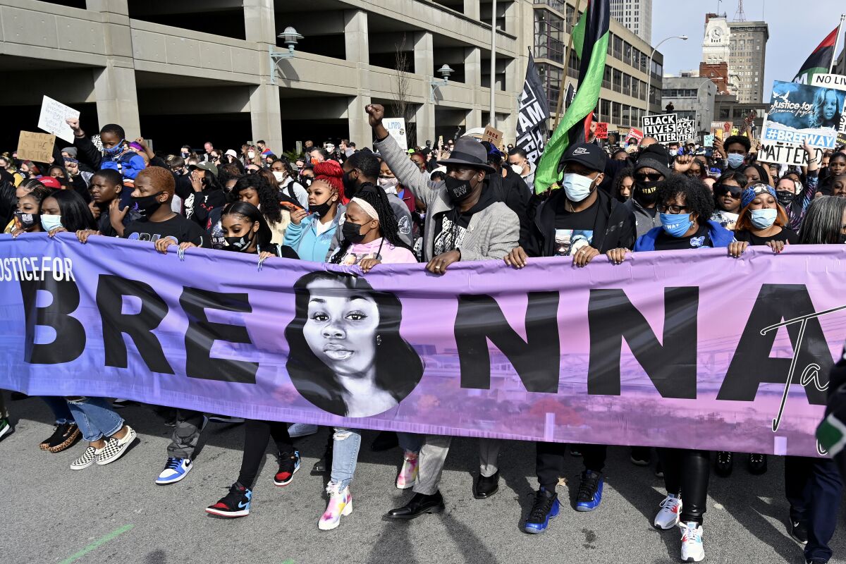 FILE - Tamika Palmer, center, the mother of Breonna Taylor, leads a march through the streets of downtown Louisville on the one year anniversary of Taylor's death on March 13, 2021, in Louisville, Ky. Questioning of potential jurors begins Tuesday, Feb. 1, 2022, for the trial of a former Kentucky police officer involved in a botched raid that killed Taylor, a 26-year-old Louisville emergency medical technician. Brett Hankison is standing trial on three counts of wanton endangerment for allegedly firing wildly into Taylor’s neighbors’ apartments in March 2020. No drugs were found during the raid, and the warrant was later found to be flawed. (AP Photo/Timothy D. Easley, File)