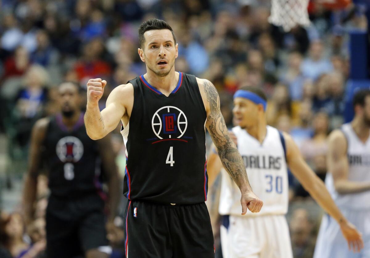 Clippers guard J.J. Redick (4) celebrates after making a three-point basket against the Mavericks during the second half Wednesday night at Staples Center.