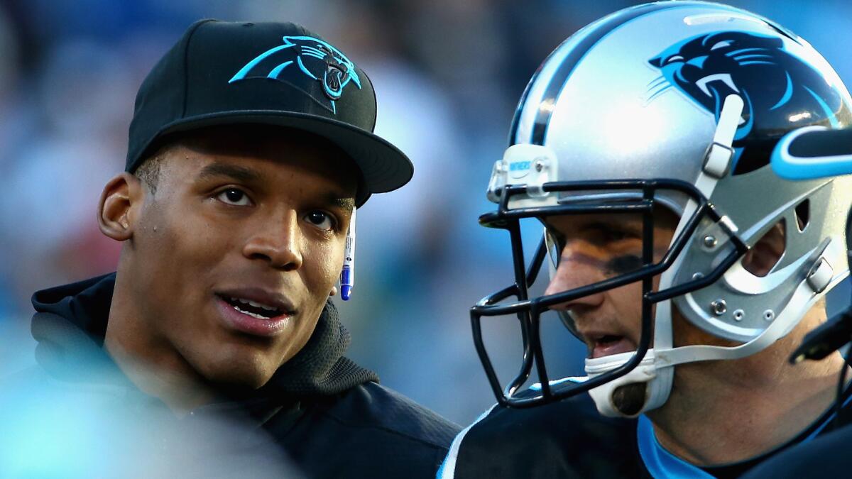 Injured Carolina Panthers quarterback Cam Newton, left, speaks with quarterback Derek Anderson during the Panthers' 19-17 win over the Tampa Bay Buccaneers on Sunday.