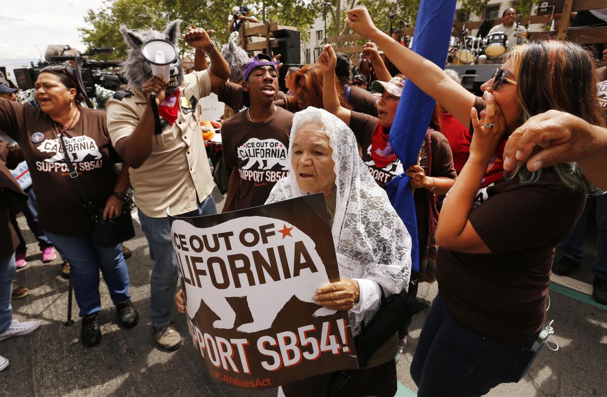 Petra Ramirez, 79, of Fresno, joins protesters as part of the "Caravan Against Fear,'' a coalition of groups that are traveling from California to Texas, calling on lawmakers and law enforcement to support sanctuary policies.