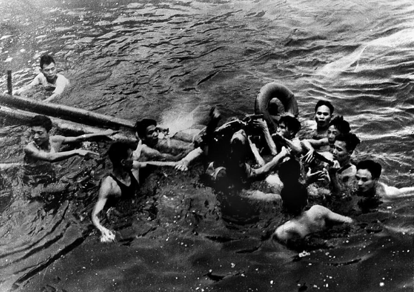 A photo taken October 26, 1967 shows U.S. Navy Airforce Major John McCain, center, being rescued from Hanoi's Truc Bach lake by several Hanoi residents after his Navy warplane was downed by the Northern Vietnamese army.
