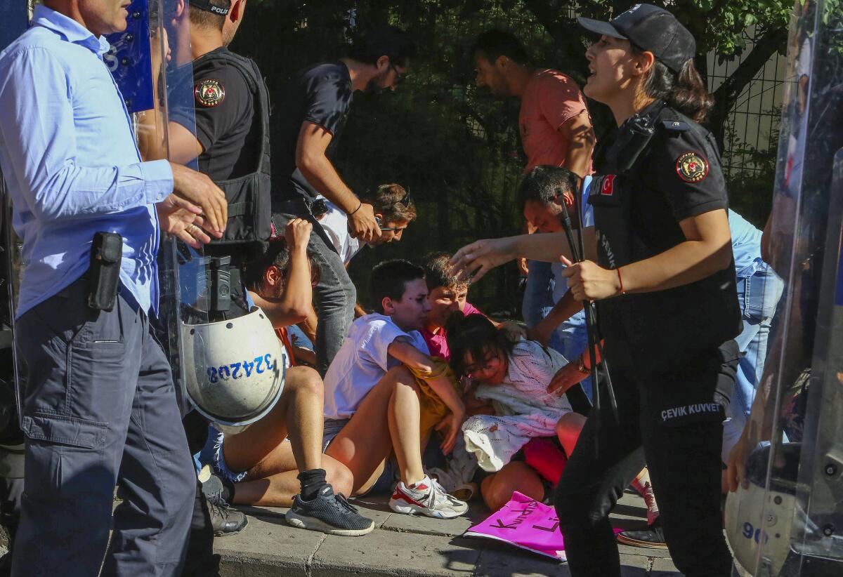 People are detained during the LGBTQ Pride March in Ankara, Turkey, Tuesday, July 5, 2022. Police in Turkey’s capital have broken up a LGBTQ Pride march and detained dozens of people. Turkish authorities have banned LGBTQ events. (AP Photo/Ali Unal)