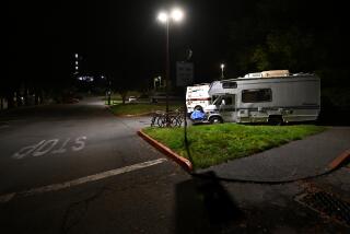 Arcata, California November 17, 2023-Students Brad Butterfield and Maddy Montiel study in their campers on the Cal Poly Humboldt campus. The university recently issued an eviction notice for students who sleep in their vehicles. (Wally Skalij/Los Angeles Times)