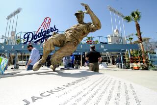 LOS ANGEL;ES, CALIFORNIA APRIL 7, 2021-A statue of baseball legend Jackie Robinson sits in the outfield.