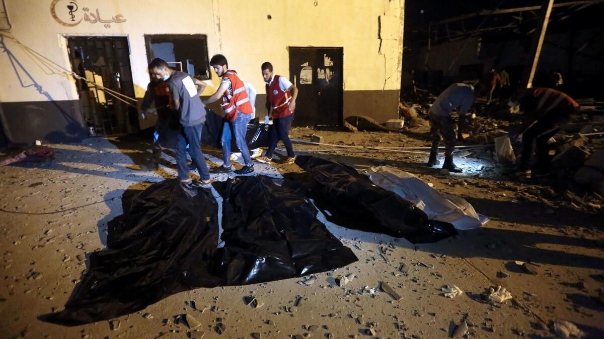 Emergency workers recover bodies after an airstrike killed dozens of migrants at Libya's Tajoura detention center, near Tripoli, on July 3, 2019.