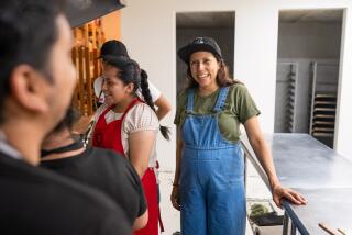 JOCOTENANGO, GUATEMALA - MAY 4, 2023: Chef Debora Fadul (right) laughs with staff and students at the cafeteria in El Patojismo, an alternative educational center for low-income urban youth. Chef Fadul teaches cooking courses at El Patojismo both for staff and students.