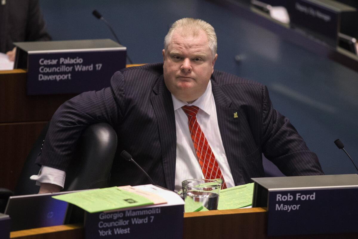 Toronto Mayor Rob Ford listens during a City Council meeting called to vote on motions to cut his budget and offer his staff positions elsewhere in the government.