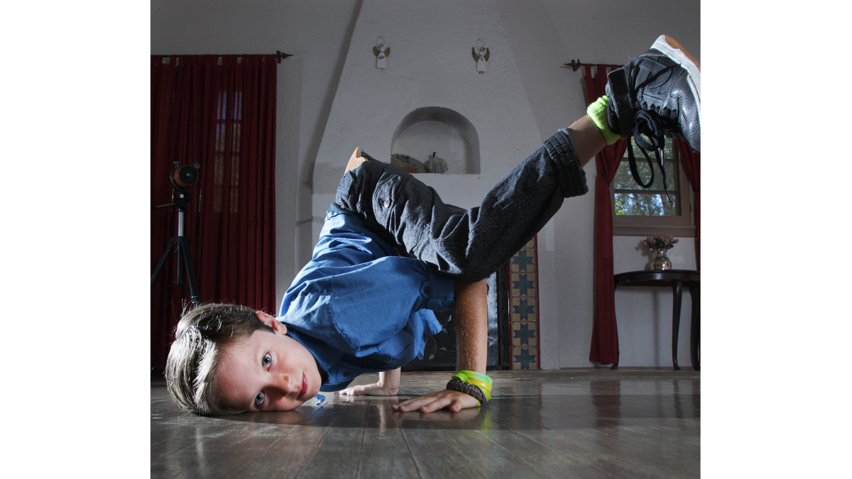 Jonah Jacobson dances at his home in Glendale. He recently held a fundraiser, where he showed off his break-dancing movies, and raised $800 for Ascencia, Glendale's largest homeless services provider.