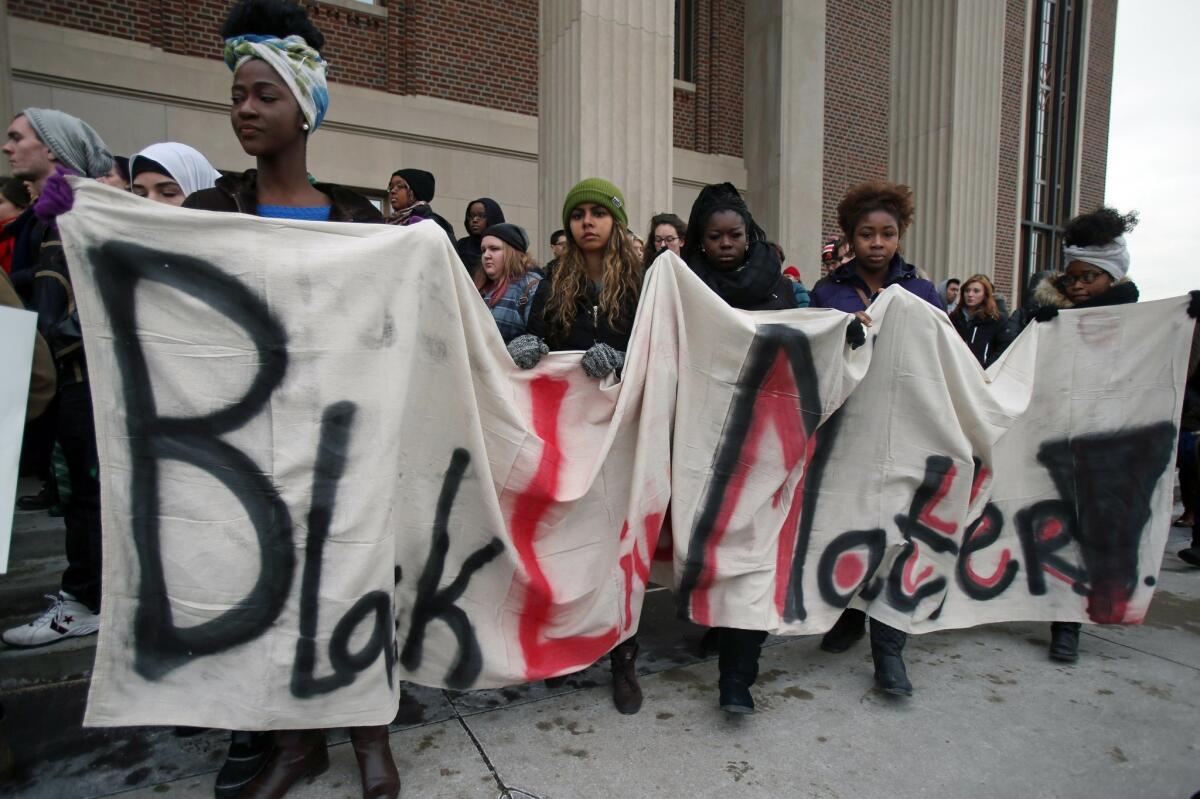 Students at the University of Minnesota carry a banner during a protest, Tuesday, Nov. 25, 2014, in Minneapolis, the day after a grand jury's decision not to indict a white Ferguson, Mo., police officer who killed Michael Brown, an unarmed black teen. (AP Photo/Jim Mone) The Associated Press