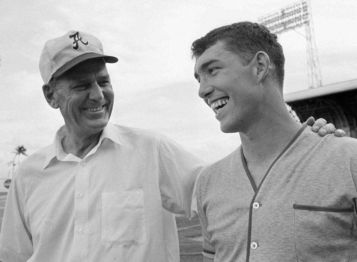 FILE - Alabama coach Bear Bryant, left, talks with his former star quarterback Steve Sloan, right, after practice in Miami for the Orange Bowl game New Years' night against Nebraska, Dec. 29, 1968. Former college coach and administrator Sloan, who played quarterback and served as athletic director at Alabama. has passed away. He was 79. Sloan died Sunday, April 14, 2024, after three months of memory care at Orlando Health Dr. P. Phillips Hospital, according to an obituary from former Alabama sports information director Wayne Atcheson. (AP Photo/Harold Valentine, File)
