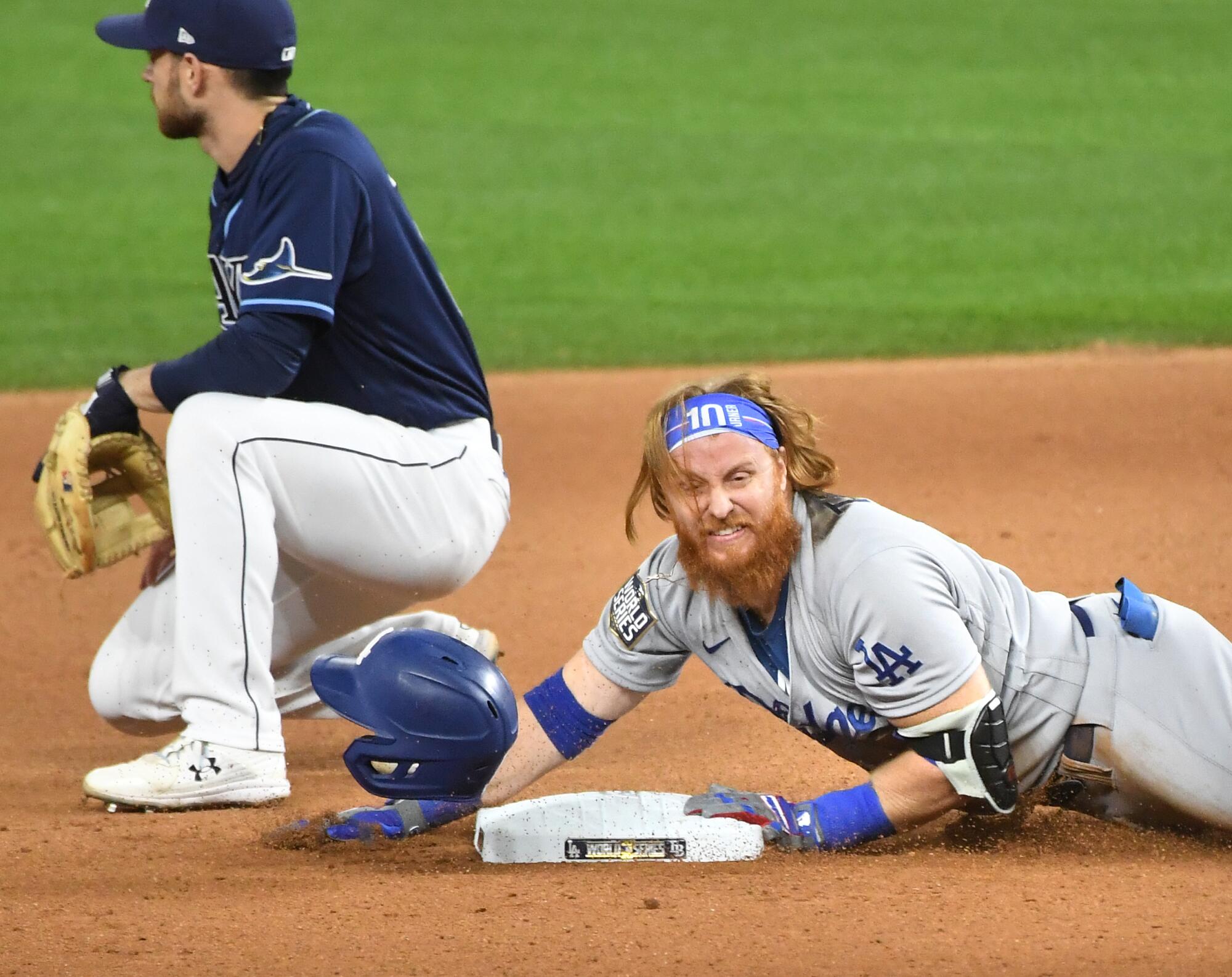 Dodgers Justin Turner slides safely for a double against the Rays in the 7th inning.