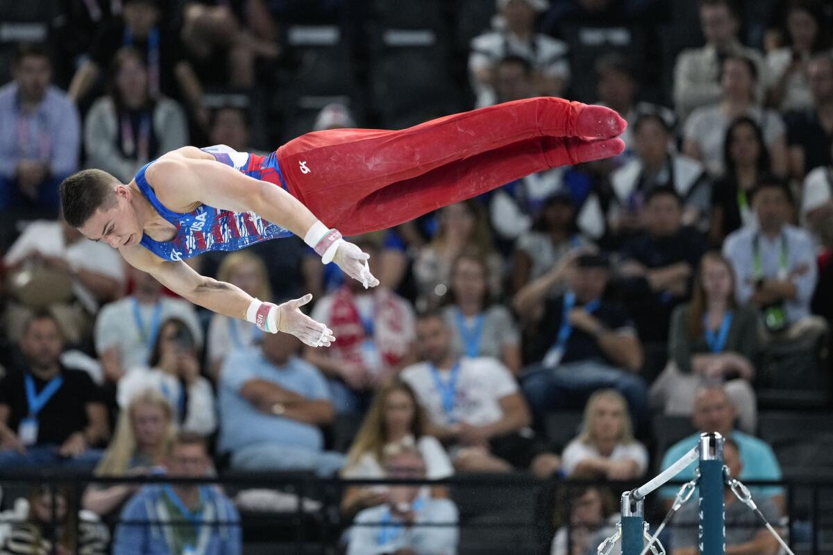 Paul Juda goes airborne and horizontal as he competes on the horizontal bar during a men's artistic gymnastics.