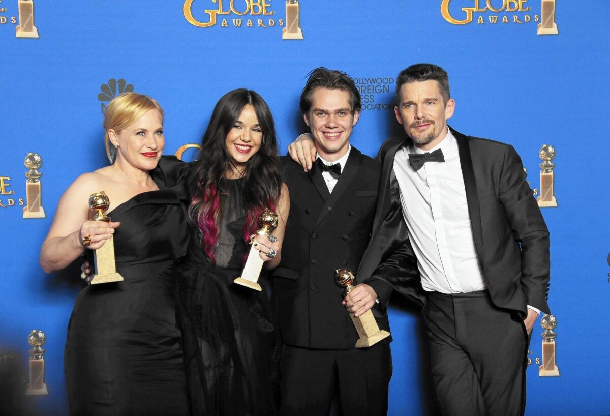 "Boyhood" cast Patricia Arquette, left, Lorelei Linklater, Ellar Coltrane and Ethan Hawke celebrate the film’s win. Arquette also won for supporting actress.