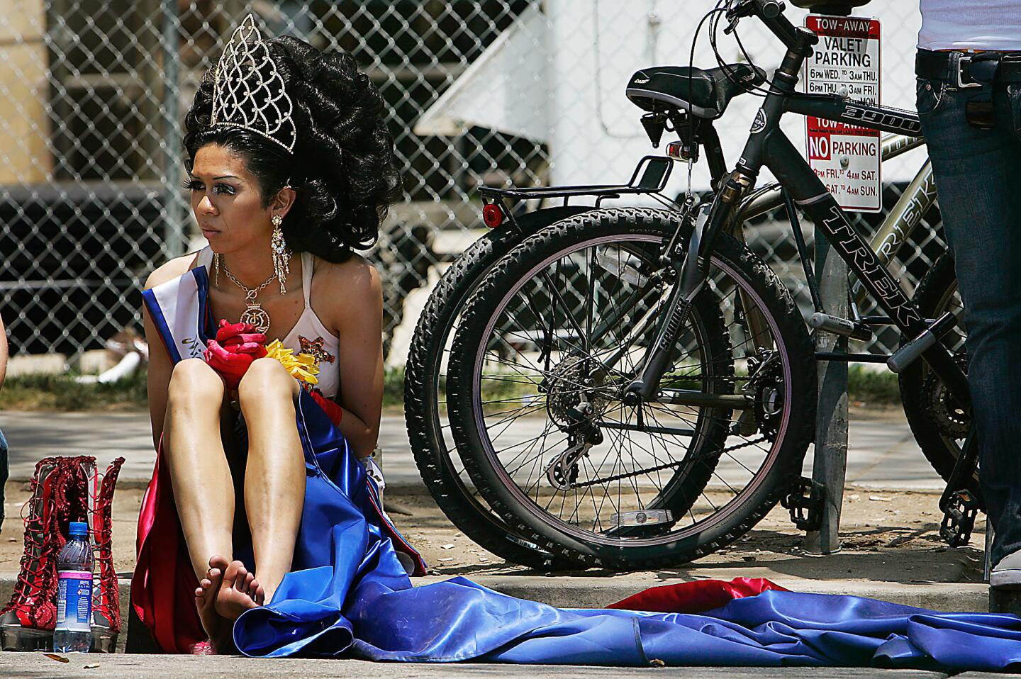 Paris Queen, Miss Gay Philippines International, rests his feet after marching with thousands of revelers in the 37th annual L.A. Pride Parade Sunday in West Hollywood. The festive street scene celebrates gay, lesbian, bisexual and transgender lifestyles.