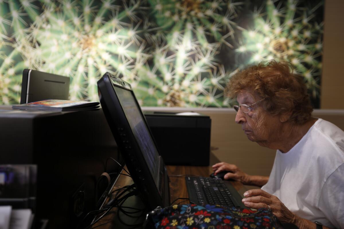 Maurine Kornfeld, 97, checks her email at the hotel before heading off to compete in the USMS Spring National Championship in Mesa, Ariz. (Francine Orr / Los Angeles Times)