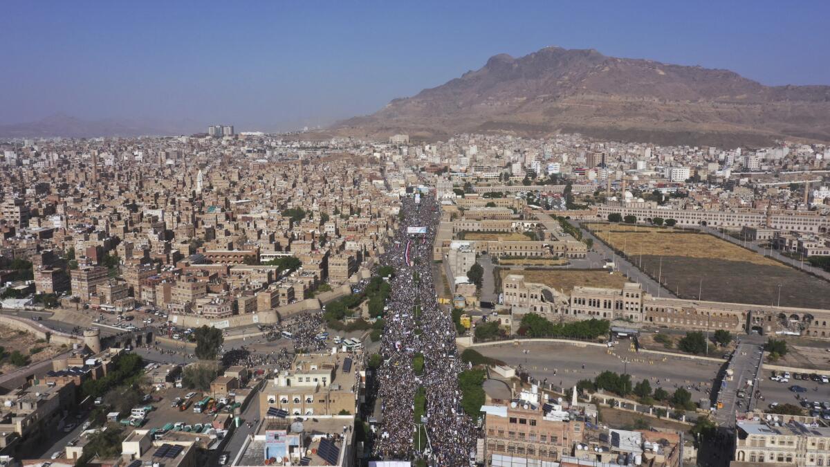 FILE - Houthi supporters attend a rally marking the seventh anniversary of the Saudi-led coalition's intervention in Yemen's war, in Sanaa, Yemen, March 26, 2022. The United Nations says Yemen’s warring parties agreed Tuesday, Aug. 2, to renew an existing truce for another two months after international concerted efforts. The U.N.'s envoy to Yemen Hans Grundberg said in a statement that Yemen’s internationally recognized government and the country’s Houthi rebels agreed to extend the truce.(AP Photo/Abdulsalam Sharhan, File)