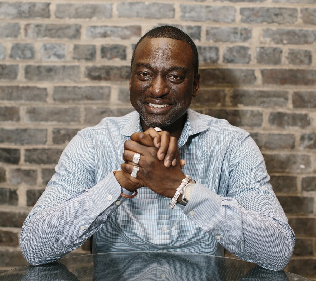 Yusef Salaam sits in front of a brick wall