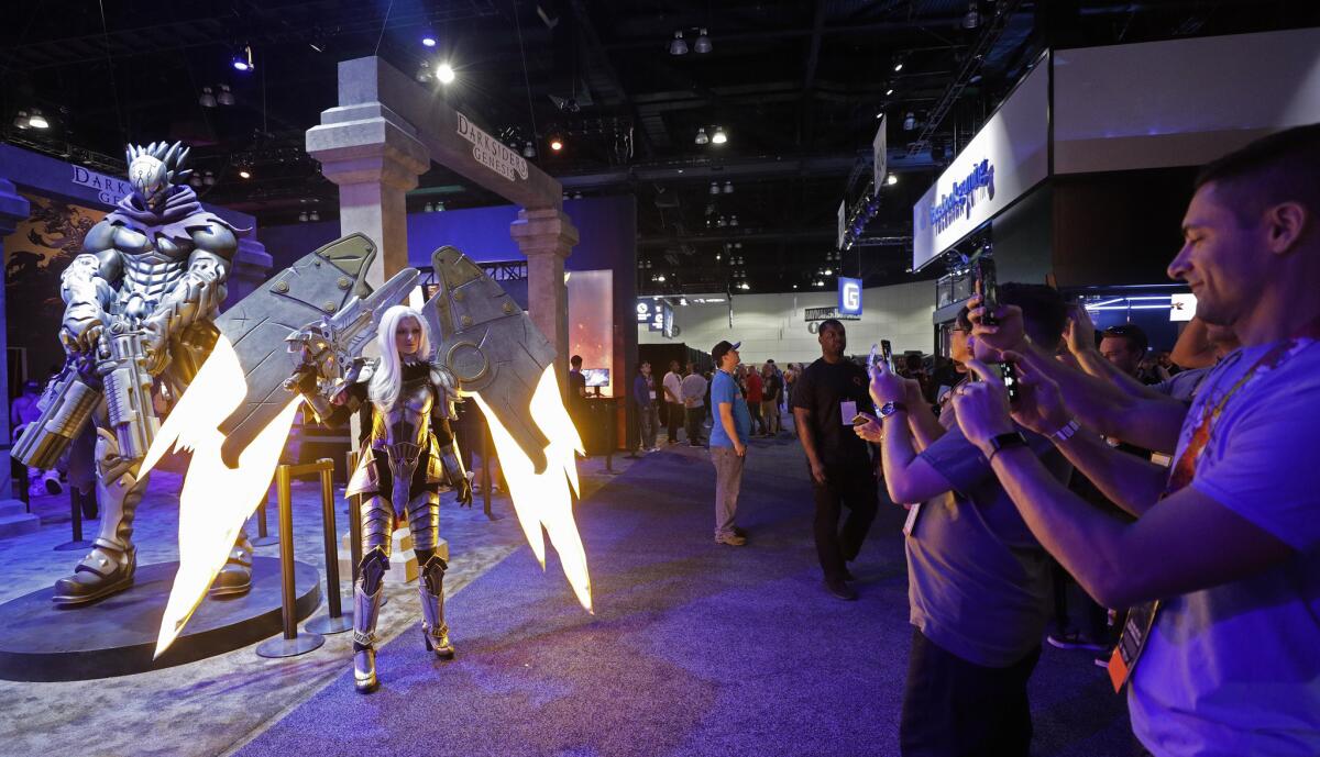 Uriel from “Darksiders: Genesis” poses for guests at the THQ Nordic booth during E3.