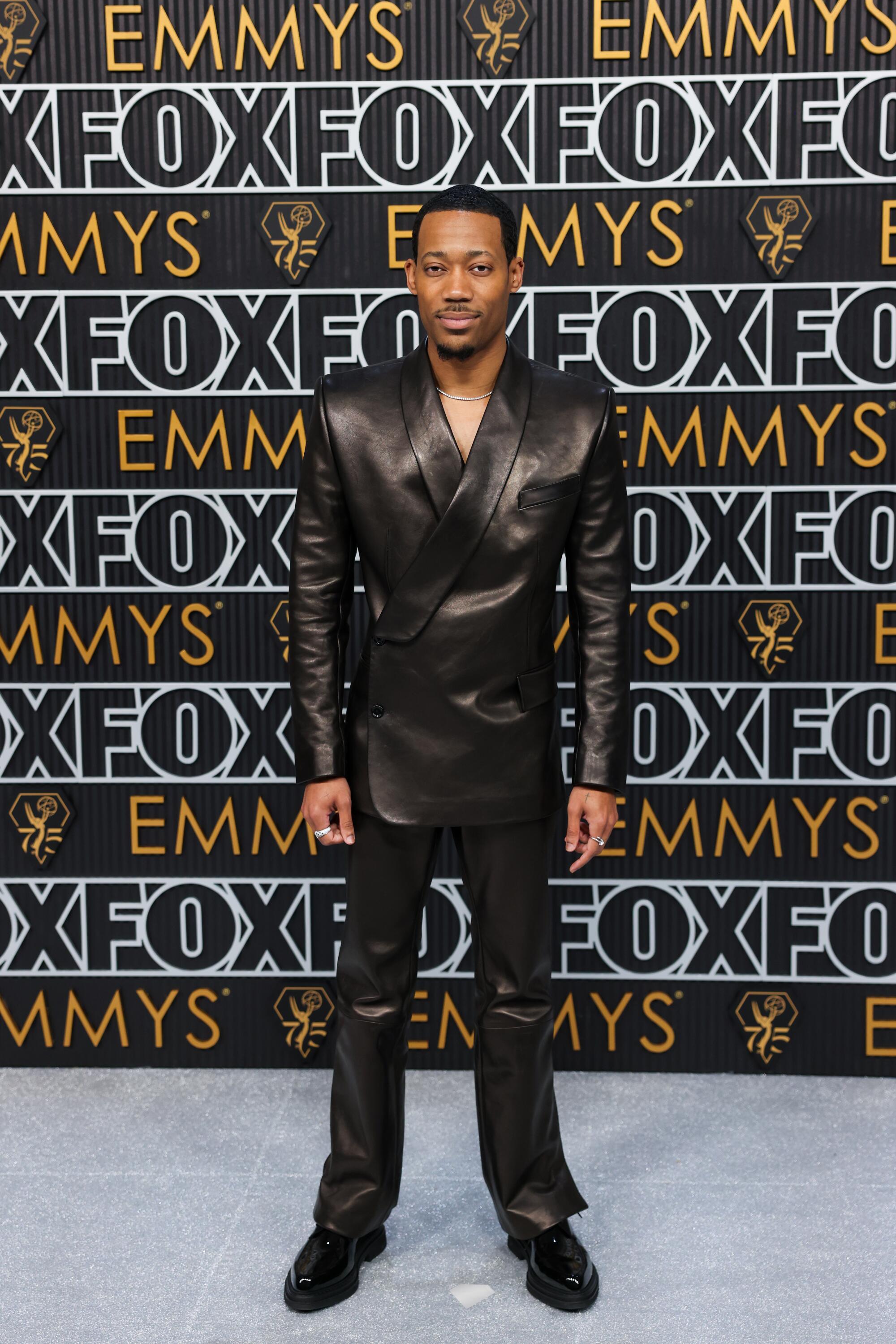 Tyler James Williams poses on the Emmys red carpet. 