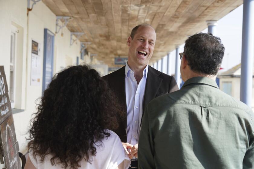 Britain's Prince William, the Prince of Wales, known as the Duke of Cornwall when in Cornwall, reacts during a visit to St. Mary's Harbour, the maritime gateway to the Isles of Scilly, England, to meet representatives from local businesses operating in the area, Friday May 10, 2024. (Ben Birchall/PA via AP)