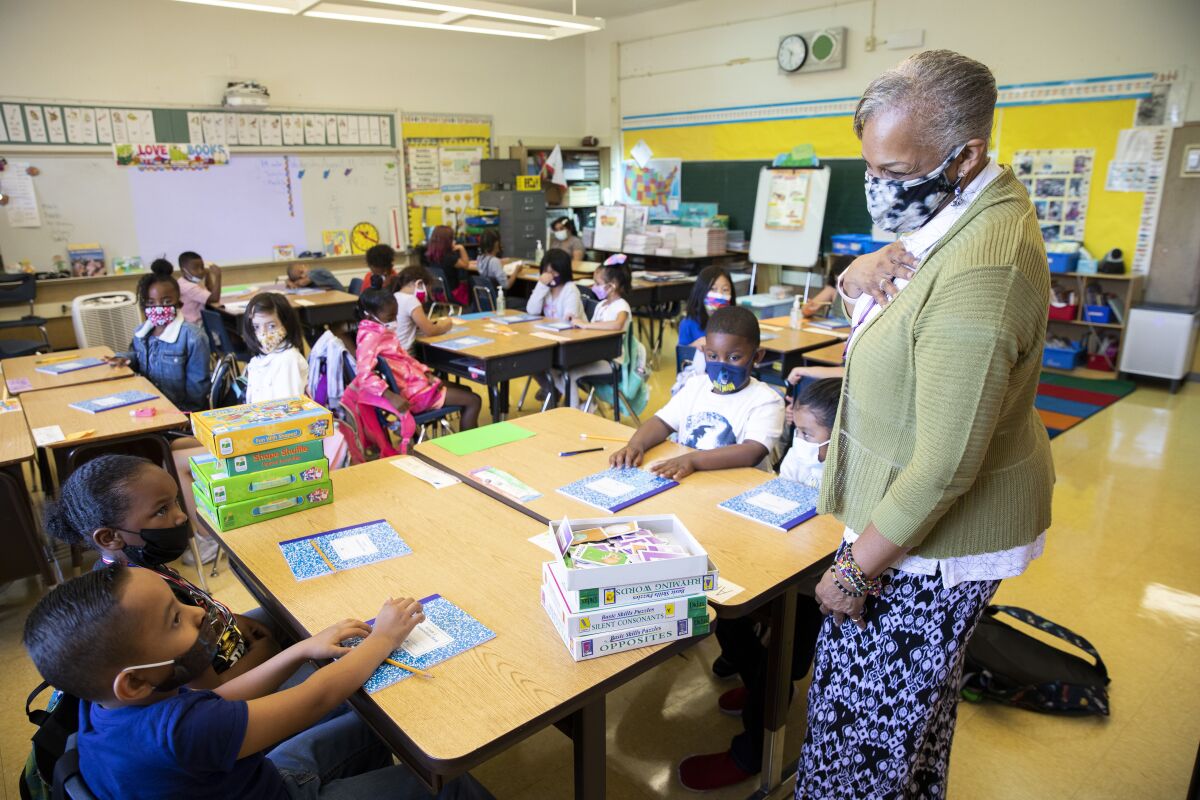 A teacher instructs second-graders in her classroom.