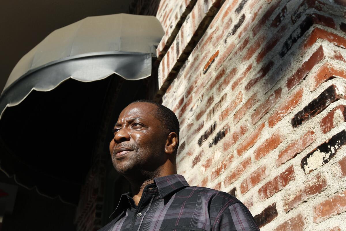 Kash Delano Register stands outside a Los Angeles restaurant in November 2013 after his release from prison. He received a $16.7-million settlement for a wrongful conviction in a 1979 armed robbery and murder.