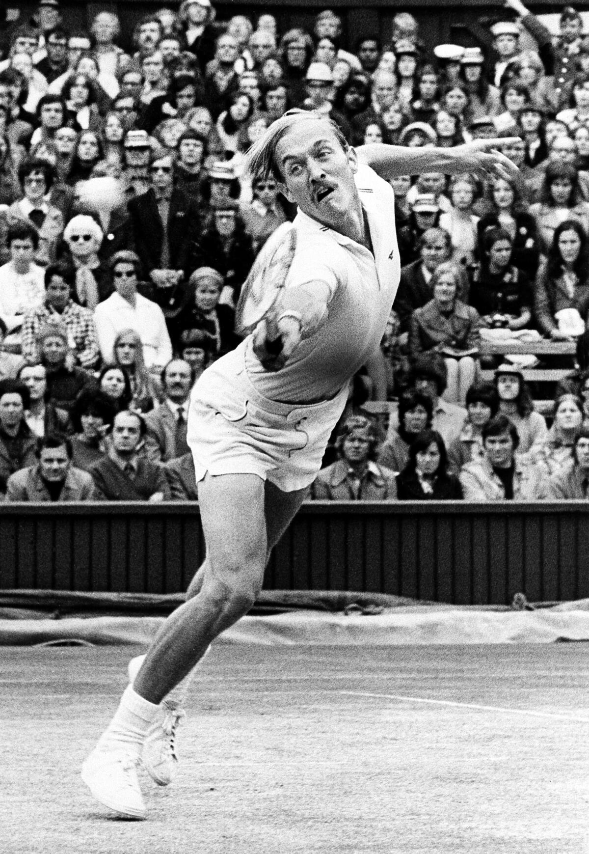 Stan Smith of the United States returns the ball to Ilie Nastase of Romania during Wimbledon action in 1972.