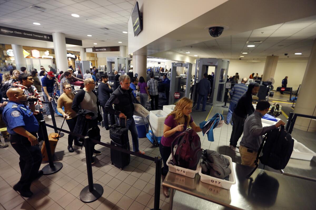 Travelers go through a security checkpoint at Los Angeles International Airport on Dec. 23, 2015.