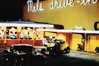 A night-time scene outside Mel's Drive-In in San Francisco, California, from the film 'American Graffiti', 1973. The film was directed by George Lucas. (Photo by Silver Screen Collection/Getty Images)