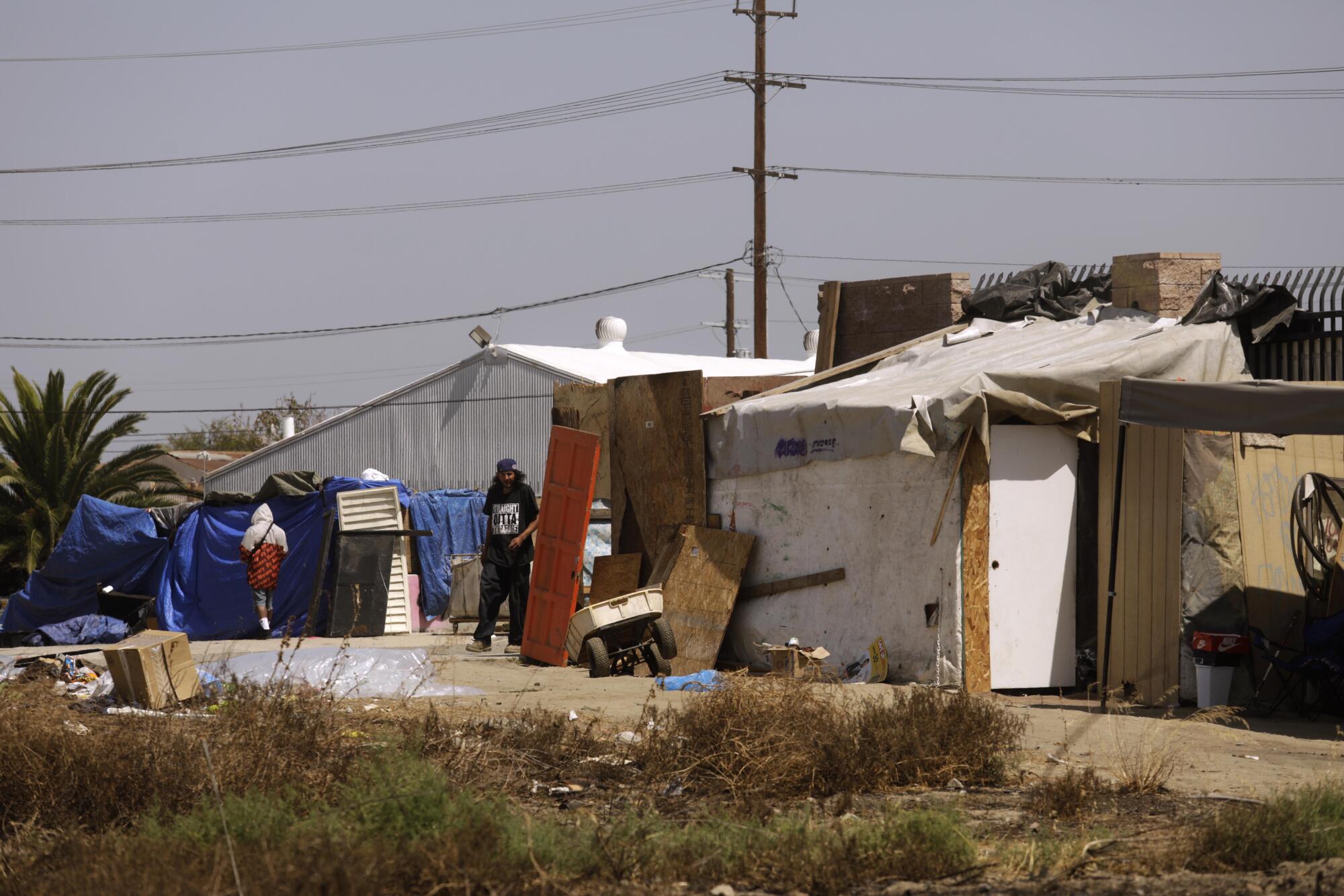 Homeless have constructed a shanty town along the periphery of a 10-acre vacant lot in Watts.