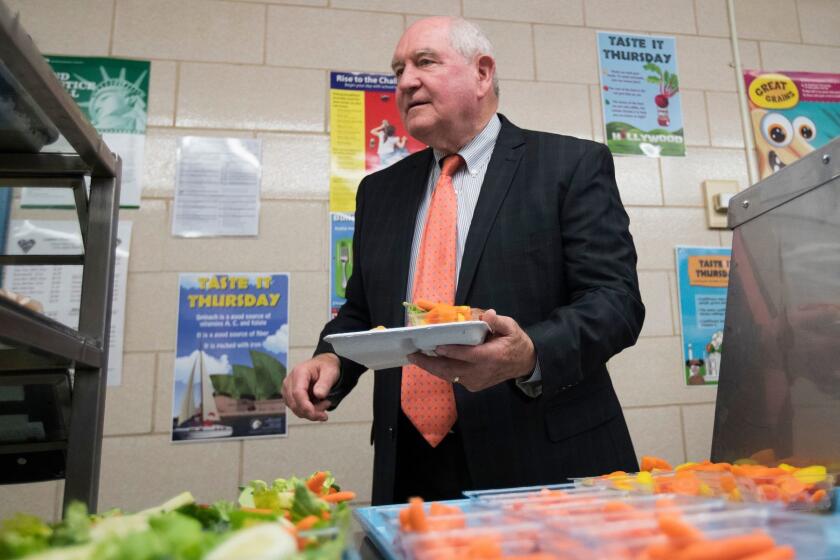 Agriculture Secretary Sonny Perdue goes though the lunch line to have lunch with students at the Catoctin Elementary School in Leesburg, Va., Monday, May 1, 2017. Agriculture Secretary Sonny Perdue unveiled a new rule on school lunches as the Trump administration and other Republicans press for flexibility after eight years of the Obama's emphasis on health eating. (AP Photo/Carolyn Kaster)