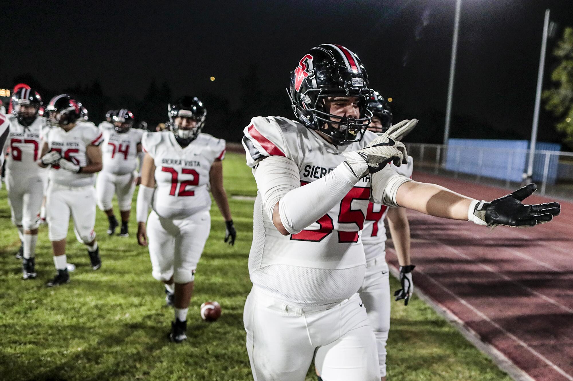 Cesar Martinez gestures in celebration after helping his team on a touchdown drive against Cerritos High.