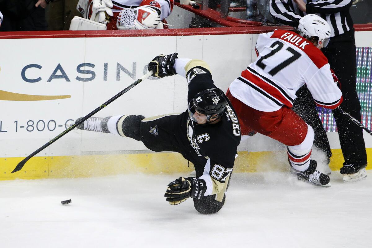 The Pittsburgh Penguins' struggles have continued and now star center Sidney Crosby, seen here colliding with Hurricanes defenseman Justin Faulk, has a lower-body injury.
