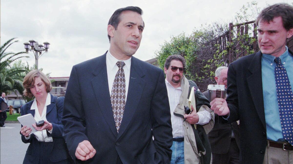 Darrell Issa talks to reporters after giving a speech to a business club in Sacramento on Tuesday, April 7, 1998.