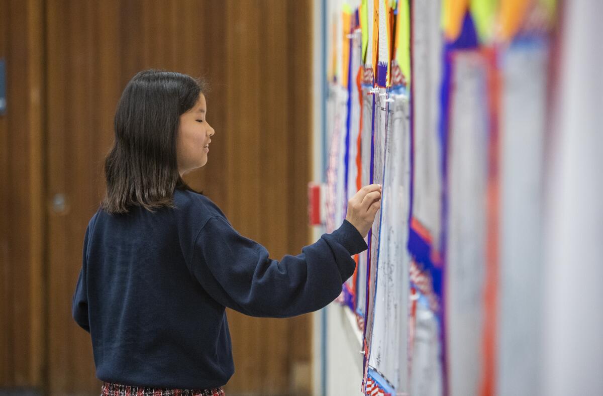 Wakana Kiuchi places a sticker on a map during Wednesday's geography bee for fifth- and sixth-graders at Lincoln Elementary School in Corona del Mar.