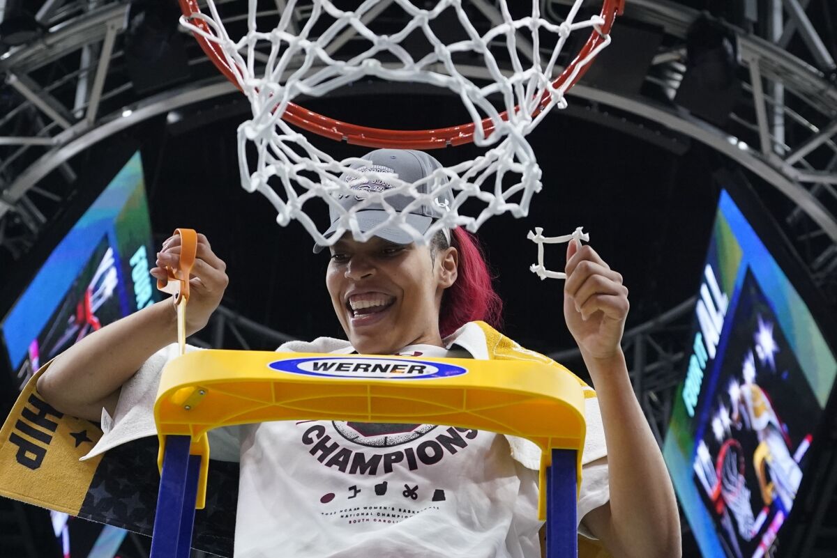 South Carolina's Victaria Saxton cuts the net after a college basketball game in the final round of the Women's Final Four NCAA tournament against UConn Sunday, April 3, 2022, in Minneapolis. South Carolina won 64-49 to win the championship. (AP Photo/Eric Gay)