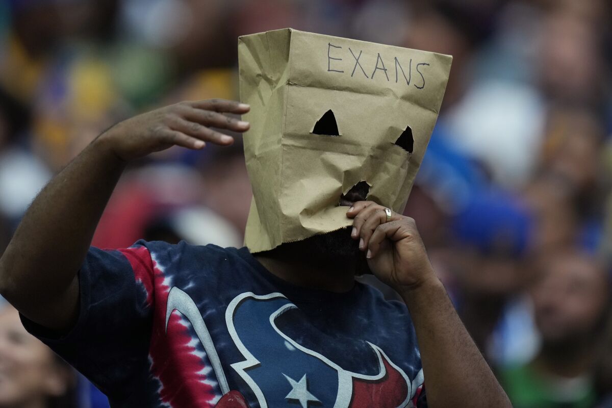 A Houston Texans fans wears a sack over his head during the team's loss during second half of an NFL football game against the Los Angeles Rams, Sunday, Oct. 31, 2021, in Houston. (AP Photo/Eric Smith)