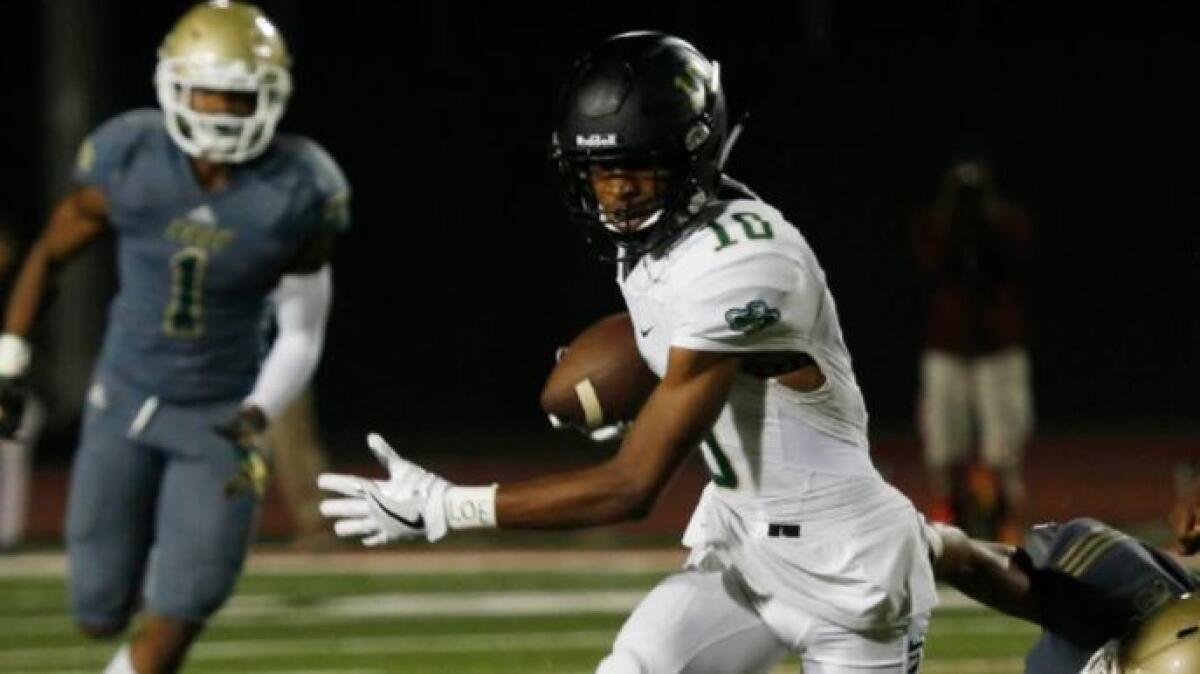 Narbonne receiver Tre Walker eludes a tackle during a game against Long Beach Poly on Sept. 2.