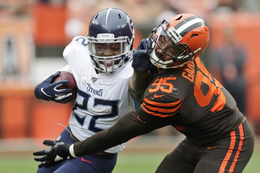Tennessee Titans running back Derrick Henry (22) called for a face mask penalty against Cleveland Browns defensive end Myles Garrett (95) during the second half in an NFL football game Sunday, Sept. 8, 2019, in Cleveland. (AP Photo/Ron Schwane)